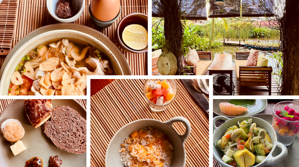 A variety of dishes including a hot pot, fruits, and baked goods arranged on a wooden surface, with a serene outdoor setting featuring tables and chairs amidst greenery.