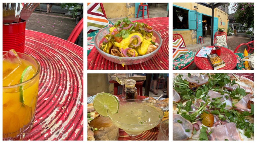 A colorful outdoor dining setup featuring a red striped table, a cocktail with lime, and vibrant chairs.